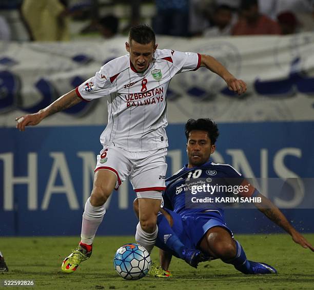 S Al-Nasr club player Luis Jimenez tries to tackle as Uzbekistan's Lokomotiv club player Server Djeparov during their Asian Champions League group A...