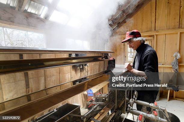 Mike Romanyshyn of Temple Tappers watches over birch syrup in an evaporator Friday, April 15, 2016.