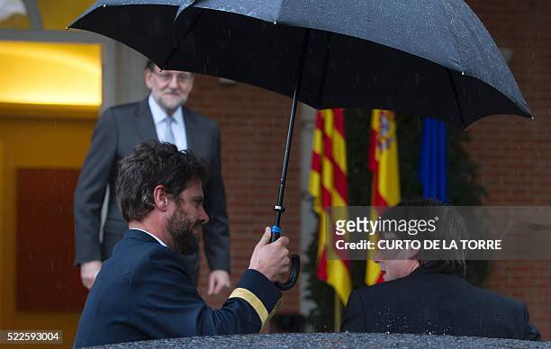 Catalan Prime Minister Carles Puigdemont is received by Spanish caretaker Prime Minister Mariano Rajoy before their meeting at La Moncloa palace in...