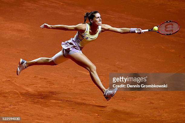 Andrea Petkovic of Germany plays a backhand in her match against Kristina Mladenovic of France during Day 3 of the Porsche Tennis Grand Prix at...