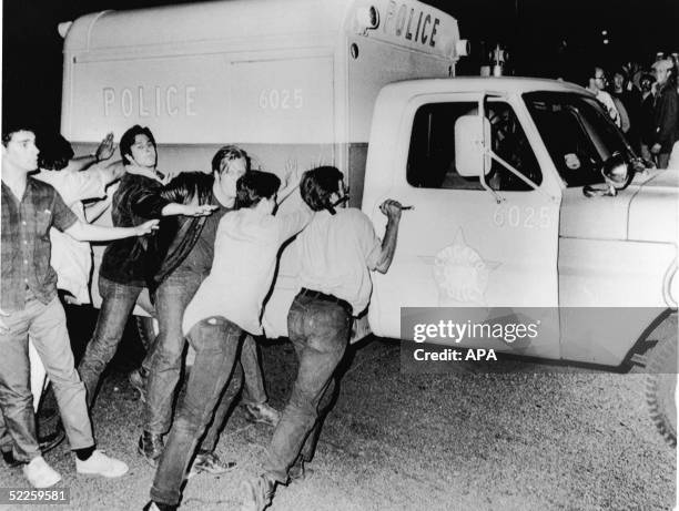 Antiwar demonstrators attempt to push over a Chicago Police Department vehicle on Michigan Avenue during the anti-Vietnam War protests surrounding...