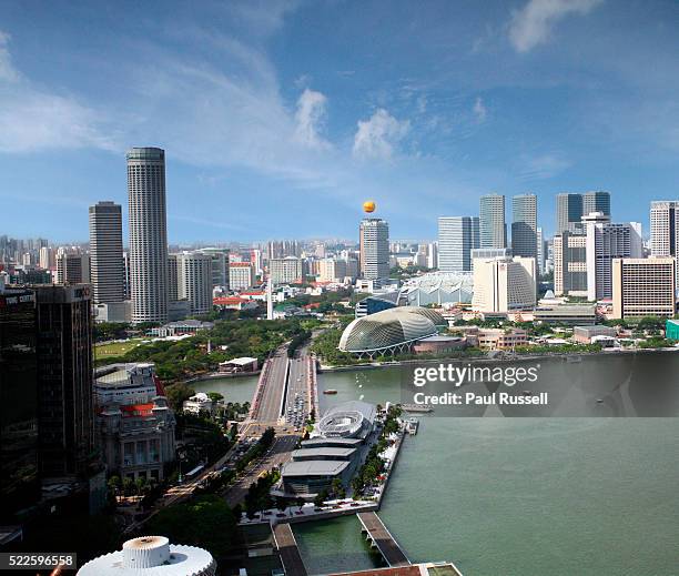 buildings adjacent to marina bay - dhl stock pictures, royalty-free photos & images