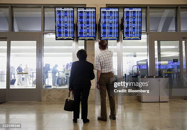 Travelers check flight times on a board at the Southwest Airlines Co. Ticket counter inside John Wayne Airport in Santa Ana, California, U.S., on...