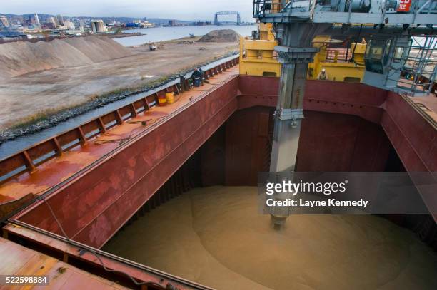 grain elevator loading grain in shipyard - grains stockfoto's en -beelden