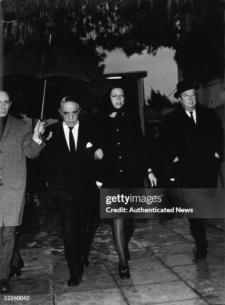 Greek shipping tycoon Aristotle Onassis and his daughter, Christina Onassis , attend the funeral of his son, Alexander Onassis, who died in a private...