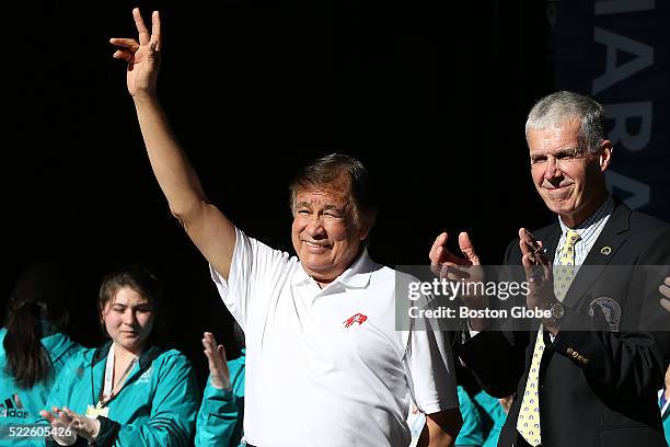 Olympian Billy Mills waves to the crowd after introduced by Thomas S. Grilk, executive director BAA, during the Official Boston Marathon Pre-Race...