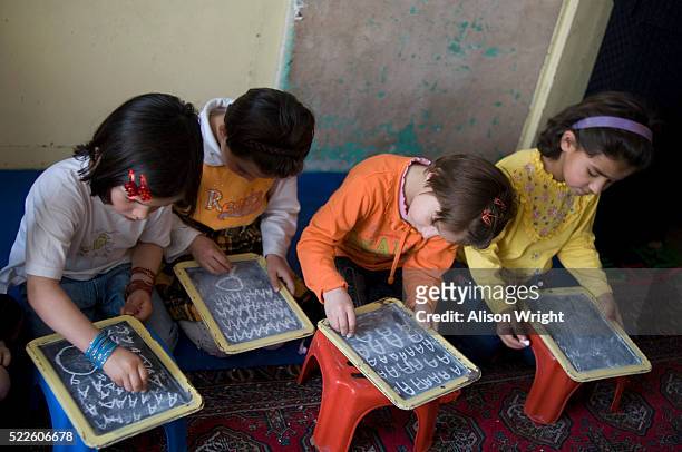 girls learning the alphabet - afghan girl stock pictures, royalty-free photos & images