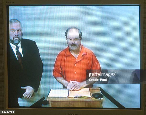 Serial murder suspect Dennis Rader appears on a video screen as he makes his first court appearance, via video feed from the Sedgwick County Jail,...