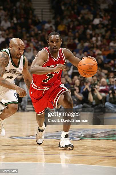 Ben Gordon of the Chicago Bulls drives around Anthony Carter of the Minnesota Timberwolves during the game on February 13, 2005 at the Target Center...