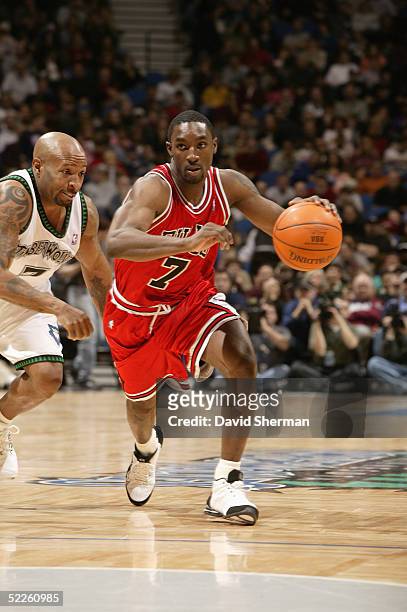 Ben Gordon of the Chicago Bulls drives around Anthony Carter of the Minnesota Timberwolves during the game on February 13, 2005 at the Target Center...