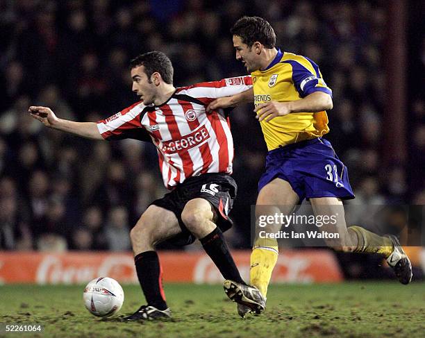Paul Telfer of Southampton tries to tackle Kevin O'Connor of Brentford during the FA Cup Fifth round Replay between Brentford v Southampton at...