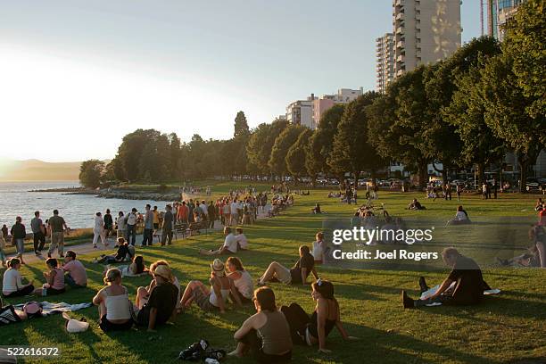 crowd at english bay beach at sunset - vancouver stock-fotos und bilder