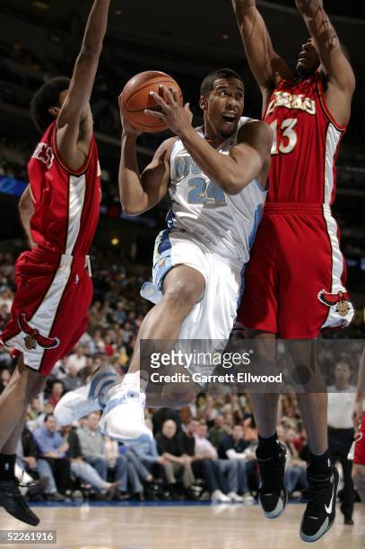 Andre Miller of the Denver Nuggets drives by Boris Diaw of the Atlanta Hawks on March 1, 2005 at the Pepsi Center in Denver, Colorado. NOTE TO USER:...