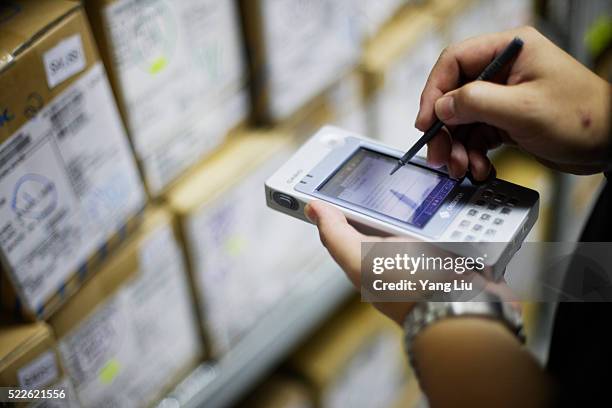 employee taking inventory on pda - warehouse inventory stock pictures, royalty-free photos & images