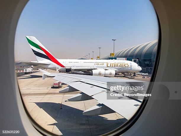 framed in the window, emirates a380 in dubai - airbus a380 stockfoto's en -beelden