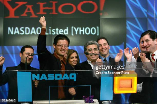 Yahoo! co-founder Jerry Yang raises his fist after ringing the opening bell at the NASDAQ with other Yahoo! employees to celebrate the 10th...