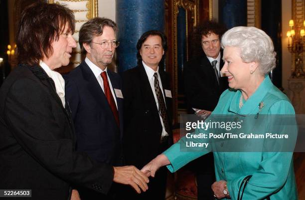 Queen Elizabeth II meets legendary guitarists Jeff Beck, Eric Clapton, Jimmy Page and Brian May at the "Music Day At The Palace" event at Buckingham...