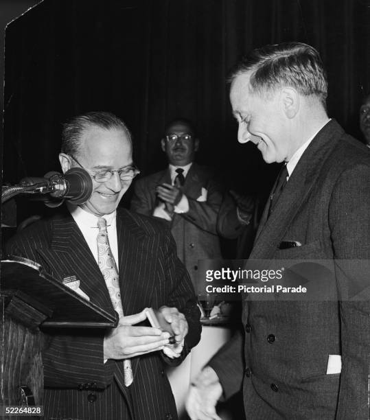 Associate Justice of the Supreme Court of the United States William O. Douglas receives the 'Father of the Year' award from Alvin Austin of the...