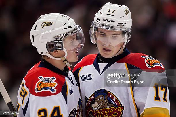 Defenceman Darren Raddysh of the Erie Otters chats with brother forward Taylor Raddysh during a game against the Windsor Spitfires on February 6,...