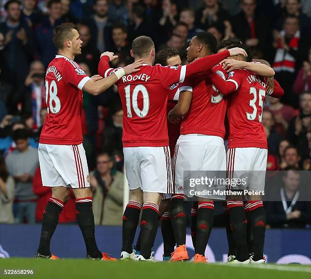 Morgan Schneiderlin, Wayne Rooney and Anthony Martial of Manchester United celebrate Damien Delaney of Crystal Palace scoring an own-goal during the...