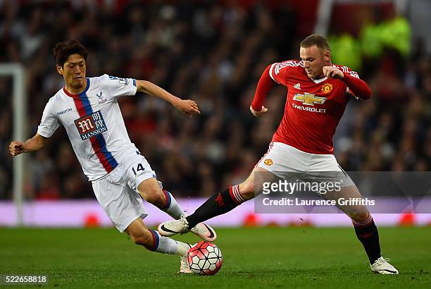 Lee Chung-yong of Crystal Palace makes a challenge on Wayne Rooney of Manchester United during the Barclays Premier League match between Manchester...