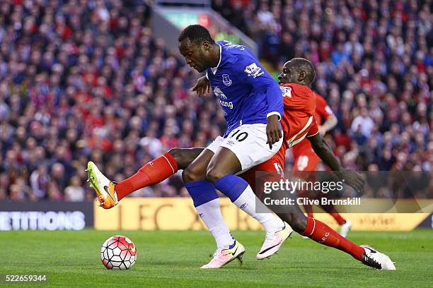 Mamadou Sakho of Liverpool makes a challenge on Romelu Lukaku of Everton during the Barclays Premier League match between Liverpool and Everton at...