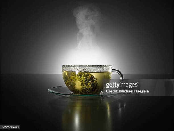 steaming cup of tea - japanese tea stock pictures, royalty-free photos & images