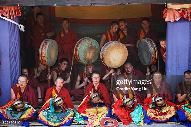 monks playing musical instruments at taer lamasery - tibetan buddhism stock pictures, royalty-free photos & images