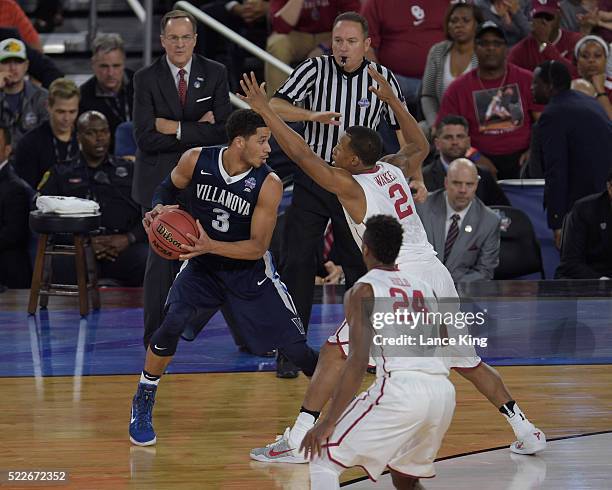 Josh Hart of the Villanova Wildcats controls the ball against Dinjiyl Walker of the Oklahoma Sooners during the 2016 NCAA Men's Final Four Semifinal...