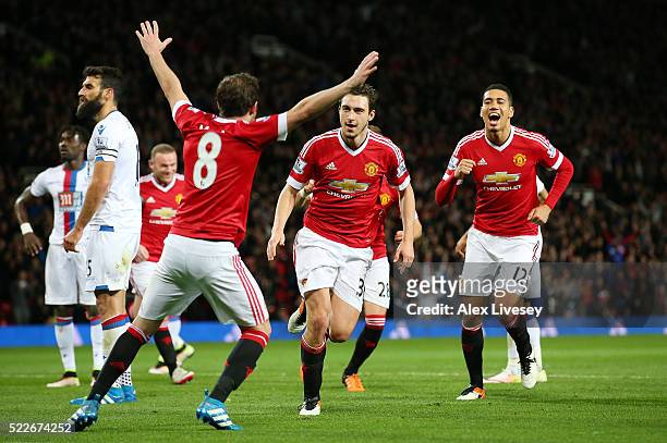 Matteo Darmian of Manchester United celebrates with team mates after scoring his sides second goal during the Barclays Premier League match between...