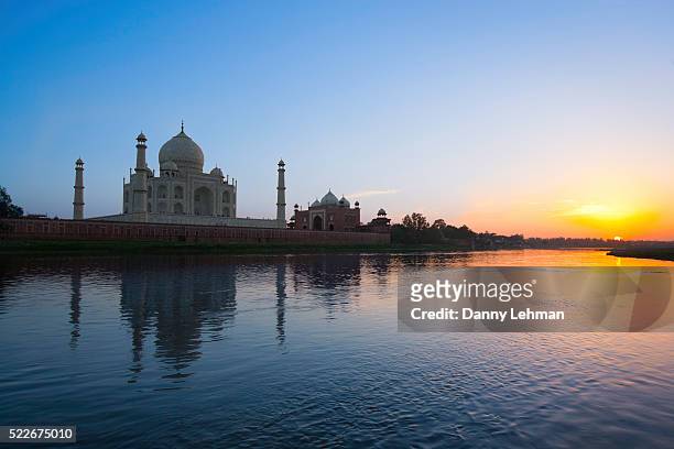 taj mahal at sunset on the yamuna river - yamuna river stock pictures, royalty-free photos & images