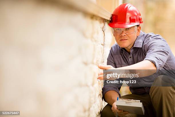 inspector or blue collar worker examines building wall outdoors. - inspector 個照片及圖片檔