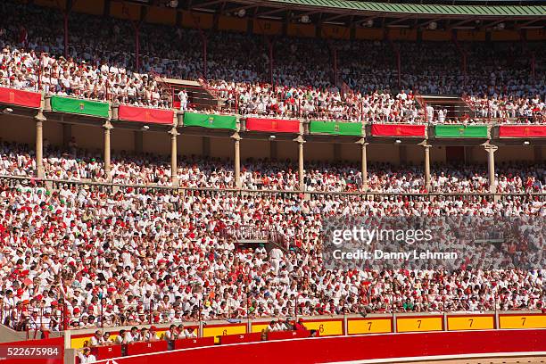 crowd in traditional dress watching bullfight during san fermin festival - fiesta of san fermin stock pictures, royalty-free photos & images