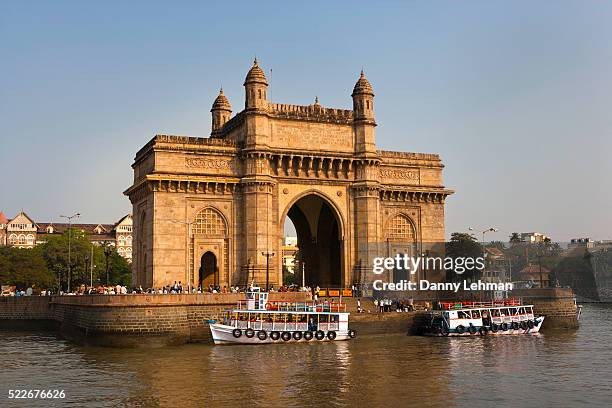 gateway of india is in the heart of mumbai's tourist district and is the citty's most famous landmark - mumbai stock pictures, royalty-free photos & images