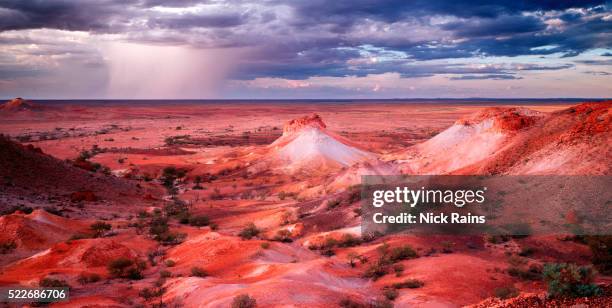 breakaways with rain in the distance - coober pedy stock pictures, royalty-free photos & images