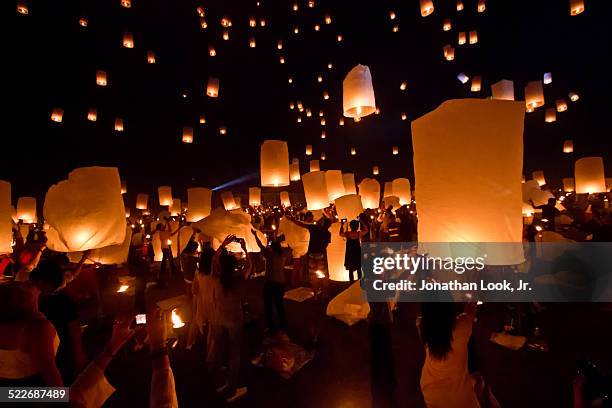 crowd releasing lanterns into sky - lantern festival bildbanksfoton och bilder