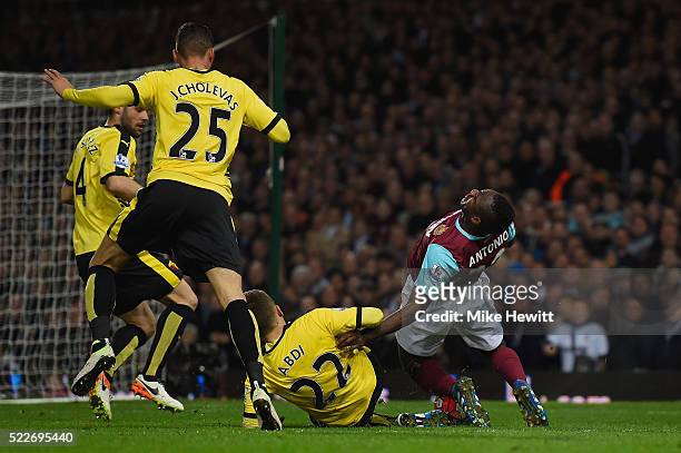 Almen Abdi of Watford makes a tackle on Michail Antonio of West Ham United during the Barclays Premier League match between West Ham United and...