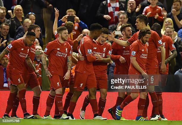 Liverpool's Brazilian midfielder Philippe Coutinho celebrates with Liverpool's English striker Daniel Sturridge and teammates after scoring their...
