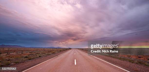 outback road with storm brewing - sunset road photos et images de collection