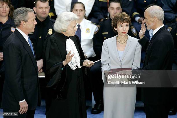 President George W. Bush watches as Homeland Security Secretary Michael Chertoff is sworn in by U.S. Supreme Court Justice Sandra Day O'Connor as his...