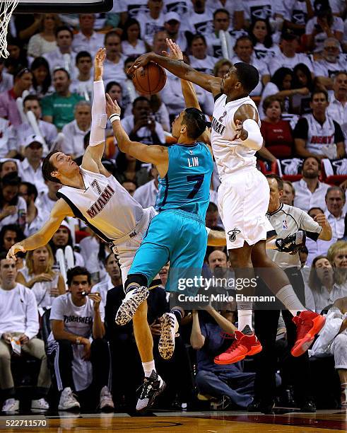 Jeremy Lin of the Charlotte Hornets is defended by Goran Dragic and Joe Johnson of the Miami Heat during game two of the Eastern Conference...