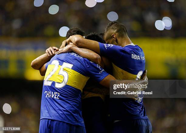 Carlos Tevez of Boca Juniors celebrates with teammates after scoring the fourth goal of his team during a match between Boca Juniors and Deportivo...