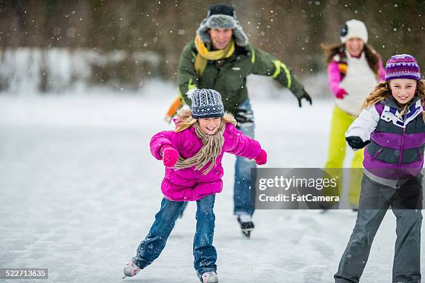 family ice-skating on pond - family ice skate stock pictures, royalty-free photos & images