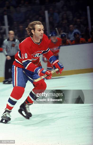 Canadian hockey player Guy Lafleur in the uniform of the Montreal Canadiens skates up the ice during a road game, late 1970s or early 1980s.