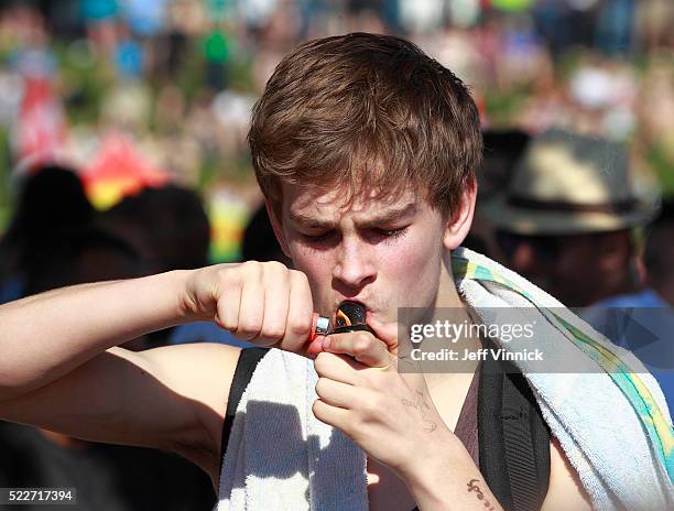 Man smokes marijuana in a pipe as thousands of people gathered at 4/20 celebrations on April 20, 2016 at Sunset Beach in Vancouver, Canada. The...