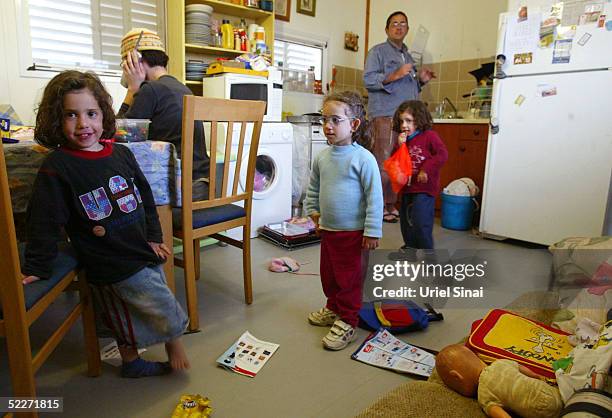 Jewish settler Gil Lichtendfeld spend time with his daughters, four-year-old Shira , Halel , three-year-old Noam and his wife Osnat at their home at...