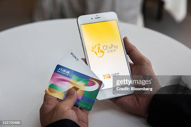 The welcome screen of the O! ePay mobile payment service app, developed by Octopus Cards Ltd., a subsidiary of MTR Corp., is displayed on an Apple...