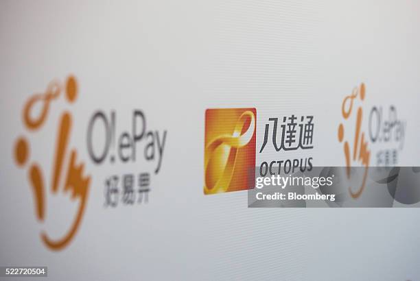 Signage for Octopus Cards Ltd., a subsidiary of MTR Corp., center, and the company's O! ePay mobile payment service are displayed at a media event in...