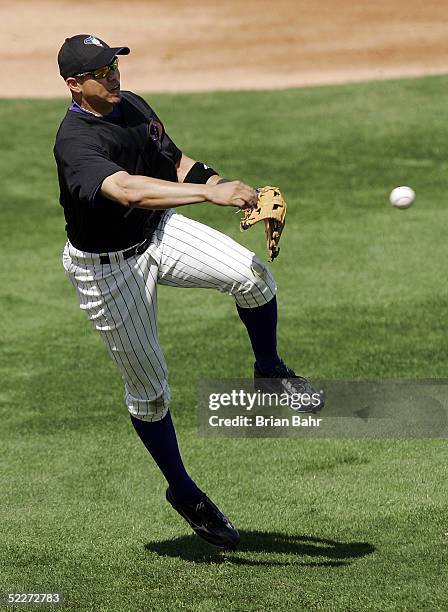 Third baseman Alex Cintron of the Arizona Diamondbacks throws a short hopper to first base against the Chicago White Sox during a spring training...