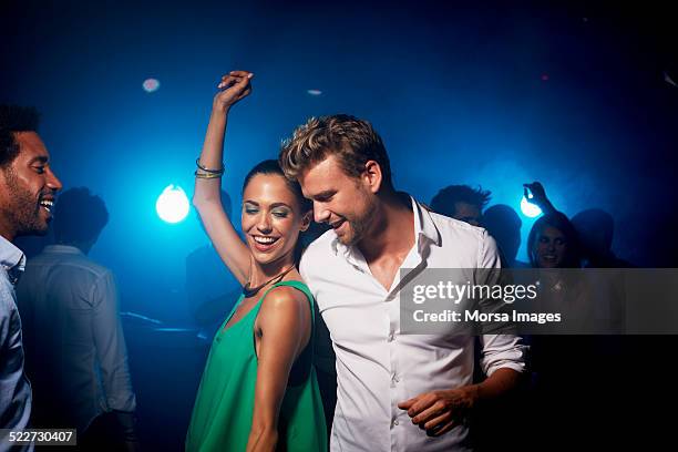 happy couple dancing in nightclub - disco dancing stock pictures, royalty-free photos & images